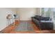 Bright living room with hardwood floors, large windows, and a comfortable black leather couch at 1979 Alcovy Shoals Blf, Lawrenceville, GA 30045
