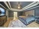 View of the main bedroom featuring a tray ceiling, wood-look floors, and a large bed at 1979 Alcovy Shoals Blf, Lawrenceville, GA 30045