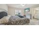 Inviting bedroom with a ceiling fan and adjoining bathroom with white cabinets and drawers at 1979 Alcovy Shoals Blf, Lawrenceville, GA 30045