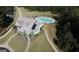 Aerial view of a residential house with backyard swimming pool and sidewalks at 555 Discovery Lake Dr, Fayetteville, GA 30215