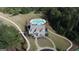 Aerial view of a residential house with backyard swimming pool and mature trees at 555 Discovery Lake Dr, Fayetteville, GA 30215