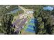 Aerial view of a residential house with backyard swimming pool, tennis court, parking, and a pond at 555 Discovery Lake Dr, Fayetteville, GA 30215