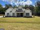 Charming single-Gathering home featuring a symmetrical facade and a well-manicured front lawn at 555 Discovery Lake Dr, Fayetteville, GA 30215