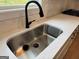 Kitchen sink with black faucet and view from the window at 555 Discovery Lake Dr, Fayetteville, GA 30215