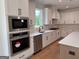 Well-lit kitchen showcasing stainless steel appliances and bright white cabinetry at 555 Discovery Lake Dr, Fayetteville, GA 30215