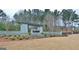 Stone monument sign for The Canoe Club featuring decorative shrubbery and lush landscaping at 555 Discovery Lake Dr, Fayetteville, GA 30215