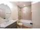 Bathroom with a bathtub, shower and a vanity with a round mirror above the sink at 5582 Rockingwood Ct, Atlanta, GA 30349