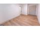 A minimalist bedroom showcasing light hardwood floors, a closet, and serene neutral walls at 5582 Rockingwood Ct, Atlanta, GA 30349