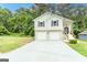 Front exterior with attached two-car garage and a concrete driveway at 5582 Rockingwood Ct, Atlanta, GA 30349