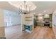 Open-concept kitchen and dining area with stainless appliances and light hardwood flooring at 5582 Rockingwood Ct, Atlanta, GA 30349