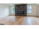 Modern living room featuring a fireplace and new vinyl flooring and large windows at 5582 Rockingwood Ct, Atlanta, GA 30349