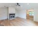 Bright living room with light hardwood floors, fireplace, and adjacent dining area at 5582 Rockingwood Ct, Atlanta, GA 30349