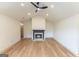 Bright living room features a modern ceiling fan, fireplace, and light hardwood floors at 5582 Rockingwood Ct, Atlanta, GA 30349