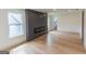 Spacious living room with a modern fireplace and windows offering exterior views at 5582 Rockingwood Ct, Atlanta, GA 30349
