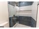 Contemporary shower with blue and white tile design and modern fixtures at 5582 Rockingwood Ct, Atlanta, GA 30349