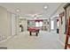 Finished basement with a pool table, basketball arcade game, and ample open space at 310 Westbourne Dr, Tyrone, GA 30290
