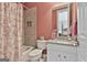 Bathroom featuring a granite countertop vanity, patterned shower curtain, and a built-in shower niche at 310 Westbourne Dr, Tyrone, GA 30290