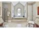Relaxing bathroom with a large soaking tub, walk-in shower, and natural light at 310 Westbourne Dr, Tyrone, GA 30290