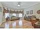 Bedroom with hardwood floors, a settee under the windows, a bed and a desk at 310 Westbourne Dr, Tyrone, GA 30290