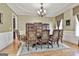 Dining room with a chandelier, rug, and cabinets with display shelves at 310 Westbourne Dr, Tyrone, GA 30290