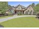 Charming brick home with a lush green lawn and beautifully landscaped front yard at 310 Westbourne Dr, Tyrone, GA 30290