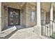 Ornate wrought-iron front door with sidelights and transom window, brick porch, and a hanging flower decoration at 310 Westbourne Dr, Tyrone, GA 30290