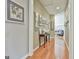 Well-lit hallway featuring hardwood floors and an assortment of artwork displayed on the walls at 310 Westbourne Dr, Tyrone, GA 30290
