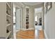 Hallway featuring hardwood floors and a built-in display cabinet leading to the bedroom at 310 Westbourne Dr, Tyrone, GA 30290