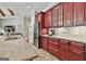 Updated kitchen features custom cabinets, granite countertops, stainless steel appliances, and tile backsplash at 310 Westbourne Dr, Tyrone, GA 30290