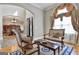 Seating area with decorative window, hardwood flooring, and wood trim at 310 Westbourne Dr, Tyrone, GA 30290