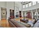 Bright living room with high ceilings, hardwood floors, fireplace, and many windows at 310 Westbourne Dr, Tyrone, GA 30290