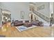 Spacious living room features hardwood floors, a coffered ceiling, and a staircase leading to the upper level at 310 Westbourne Dr, Tyrone, GA 30290