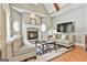 Cozy living room featuring a stone fireplace, arched windows, comfortable seating, and a stylish area rug at 310 Westbourne Dr, Tyrone, GA 30290