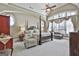 Spacious main bedroom with a four-poster bed, arched windows, and elegant decor at 310 Westbourne Dr, Tyrone, GA 30290