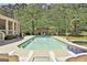 A swimming pool has clear blue water and features a jacuzzi and a poolside lounge area at 310 Westbourne Dr, Tyrone, GA 30290