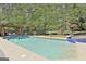 Inviting backyard featuring a large pool, spa, patio, and a beautiful pergola with lounge chairs at 310 Westbourne Dr, Tyrone, GA 30290