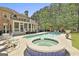 Beautiful backyard with swimming pool, hot tub, pergola, lounge chairs, and screened-in porch at 310 Westbourne Dr, Tyrone, GA 30290