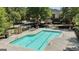 Aerial view of the fenced neighborhood pool featuring lounge chairs and umbrellas for relaxation and sunbathing at 310 Westbourne Dr, Tyrone, GA 30290