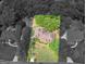 Aerial view of a brick home surrounded by mature trees on a large lot at 1466 Lake Forest Ln, Mcdonough, GA 30253