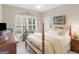 Cozy bedroom with four poster bed, shuttered windows and plush carpets at 1466 Lake Forest Ln, Mcdonough, GA 30253
