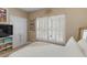 Bright bedroom with a large window with shutter blinds and double closets at 1466 Lake Forest Ln, Mcdonough, GA 30253