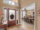 Inviting foyer with beautiful front door and hardwood floors lead into the dining area at 1466 Lake Forest Ln, Mcdonough, GA 30253