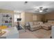 Large living room and multi purpose room featuring a ceiling fan and carpeted floors at 1466 Lake Forest Ln, Mcdonough, GA 30253
