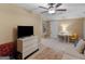 Spacious multi purpose living room featuring a ceiling fan, a dresser, and seating at 1466 Lake Forest Ln, Mcdonough, GA 30253