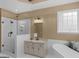 Luxurious main bathroom with glass shower, soaking tub, and granite countertop at 1466 Lake Forest Ln, Mcdonough, GA 30253