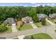 Beautiful aerial view of well-maintained homes with lush landscaping and long driveways in a desirable neighborhood at 7020 Grand View Way, Suwanee, GA 30024
