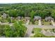 Residential aerial view showcasing manicured lawns, mature trees, and well-spaced homes in a suburban neighborhood at 7020 Grand View Way, Suwanee, GA 30024