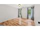 Cozy bedroom with two windows, hardwood floors and decorative curtains at 7020 Grand View Way, Suwanee, GA 30024