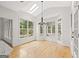 Bright breakfast nook with large windows, skylight, and wood floors; chandelier and access to screened porch at 7020 Grand View Way, Suwanee, GA 30024