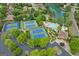 Overhead view of community amenities with tennis courts, a swimming pool, and a lake in a beautifully landscaped setting at 7020 Grand View Way, Suwanee, GA 30024